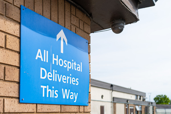 All hospital deliveries this way sign on building wall