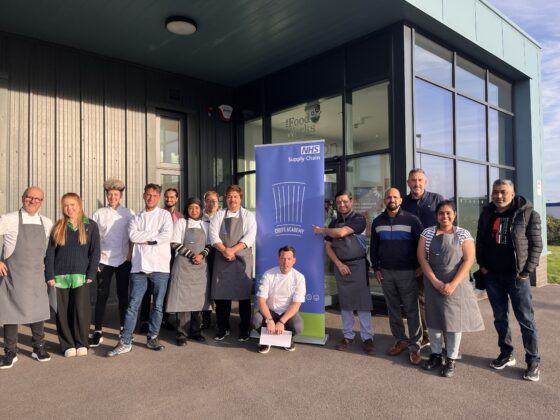 Chefs academy Bristol attendees and NHS Supply Chain: Food Dietic team pose outside building with chefs academy banner. 