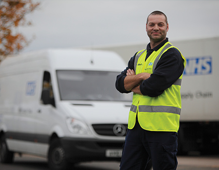 Driver standing in front of NHS Supply Chain van