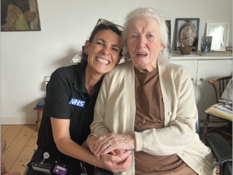 An ambulance staff member attending to an elderly patient in a community setting with ultra-portable X-ray