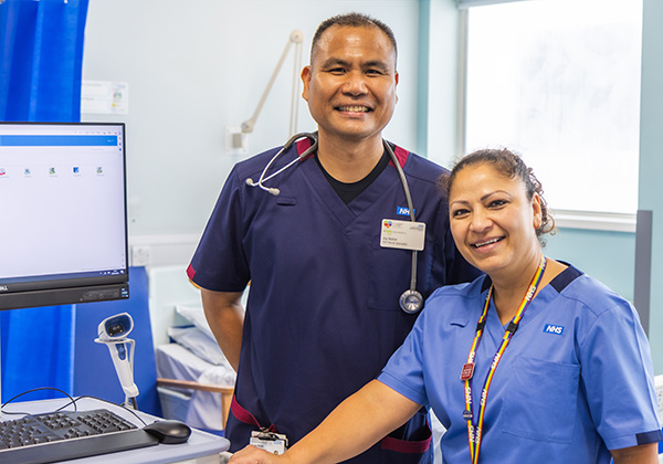 Two healthcare workers in NHS Healthcare Uniforms