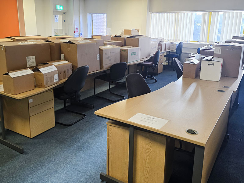 Packaging boxes on desks in an office