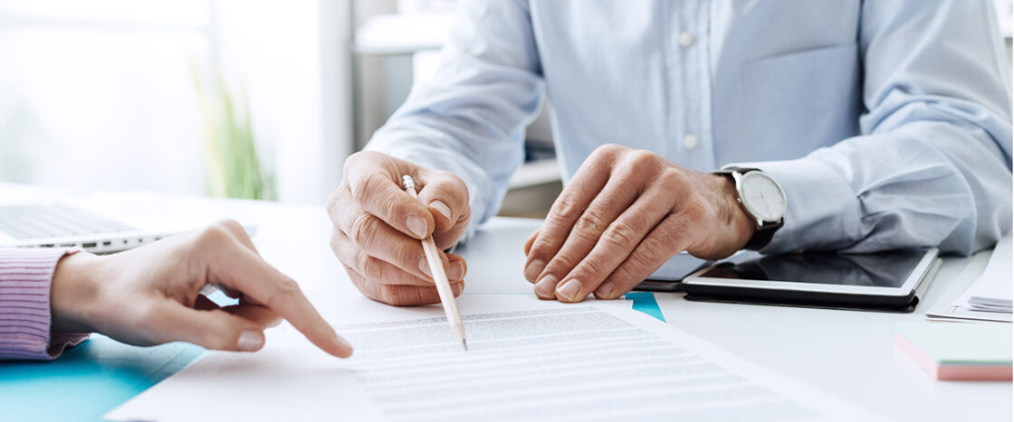 Two people discussing a contract