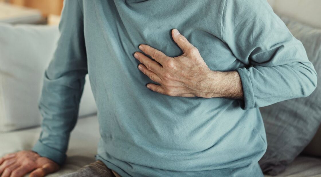 Chest pain heart attack patient at home on sofa