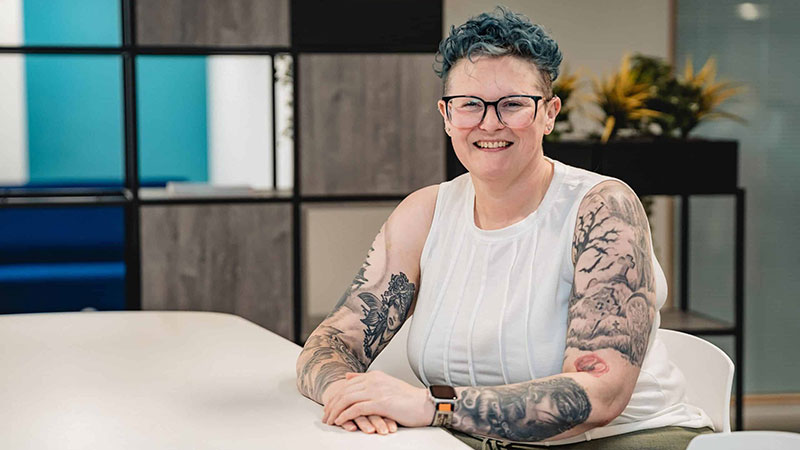 Heidi Barnard sitting a a desk
