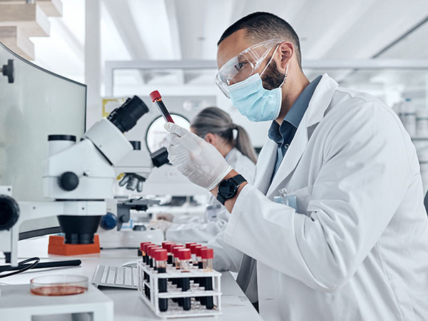 Laboratory worker with microscope