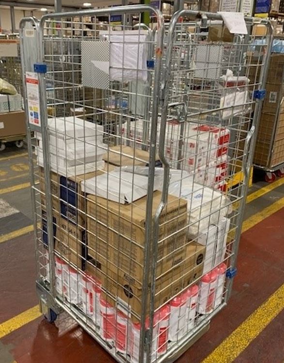 A roll cage in a warehouse ready for deliveries