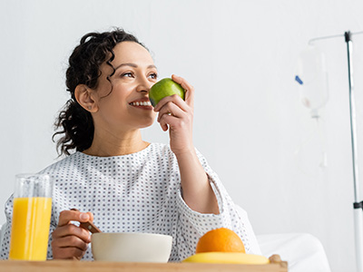 A patient eating an apple in hospital