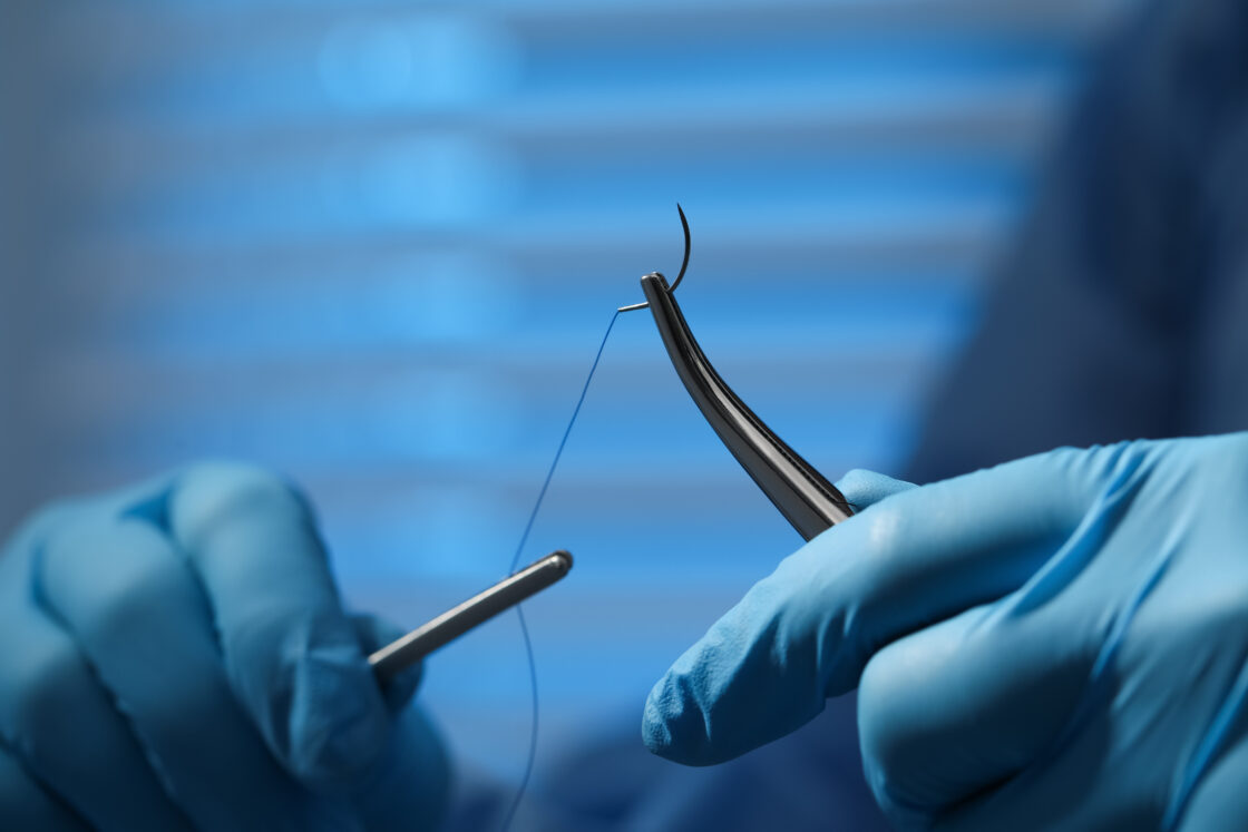 Surgeon - forceps - suture thread